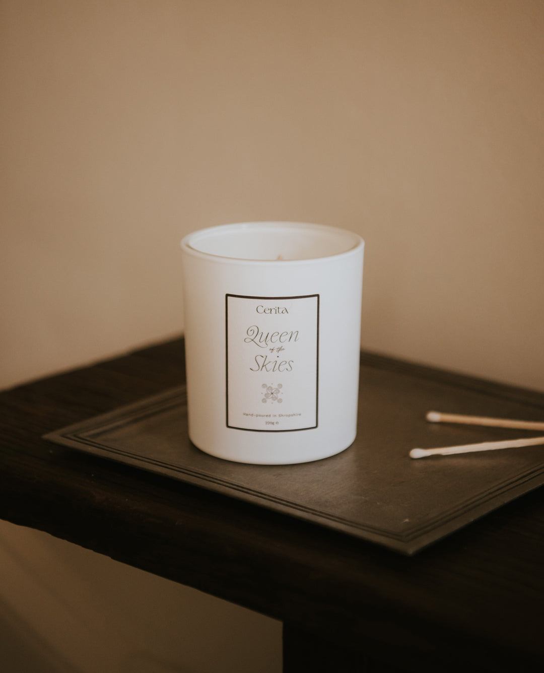 aromatherapy candle by Cerita on metal tray with neutral background