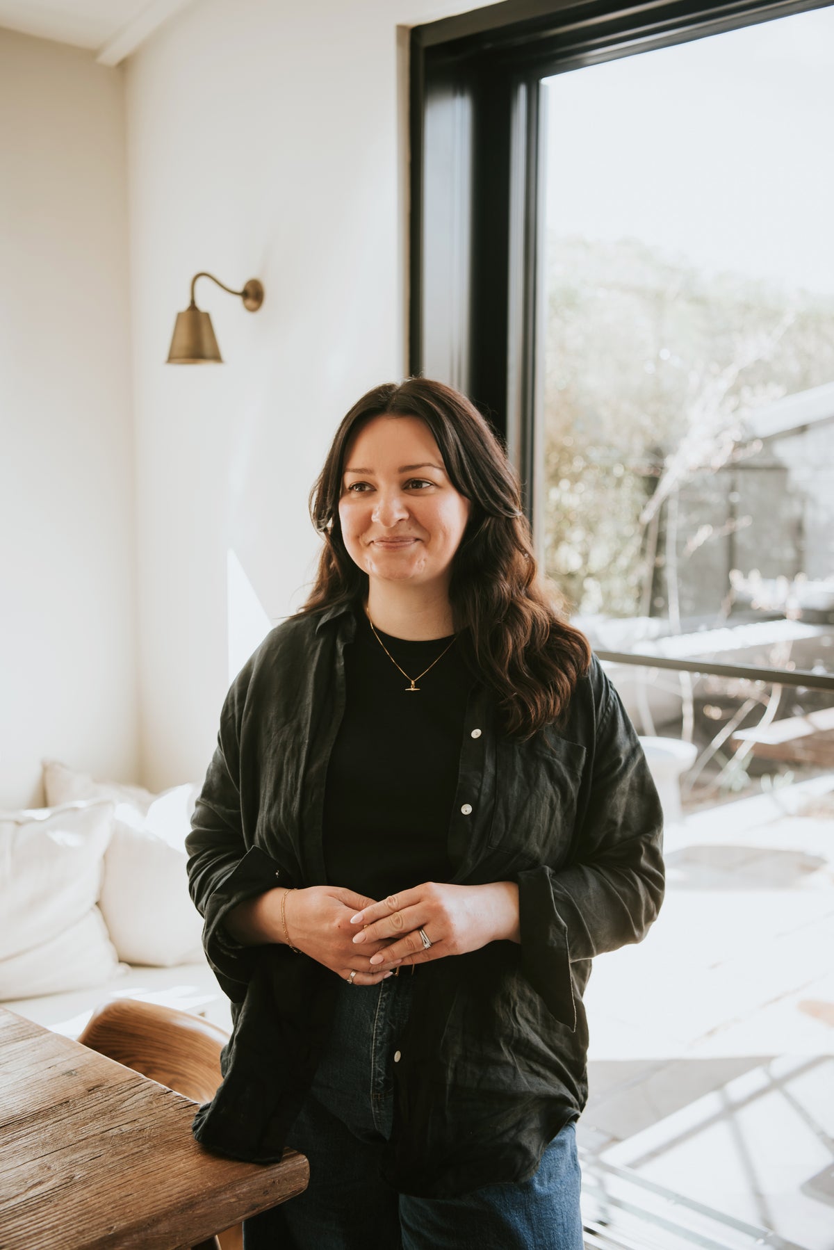female founder of wellbeing and lifestyle brand Cerita standing in natural light-filled interior setting
