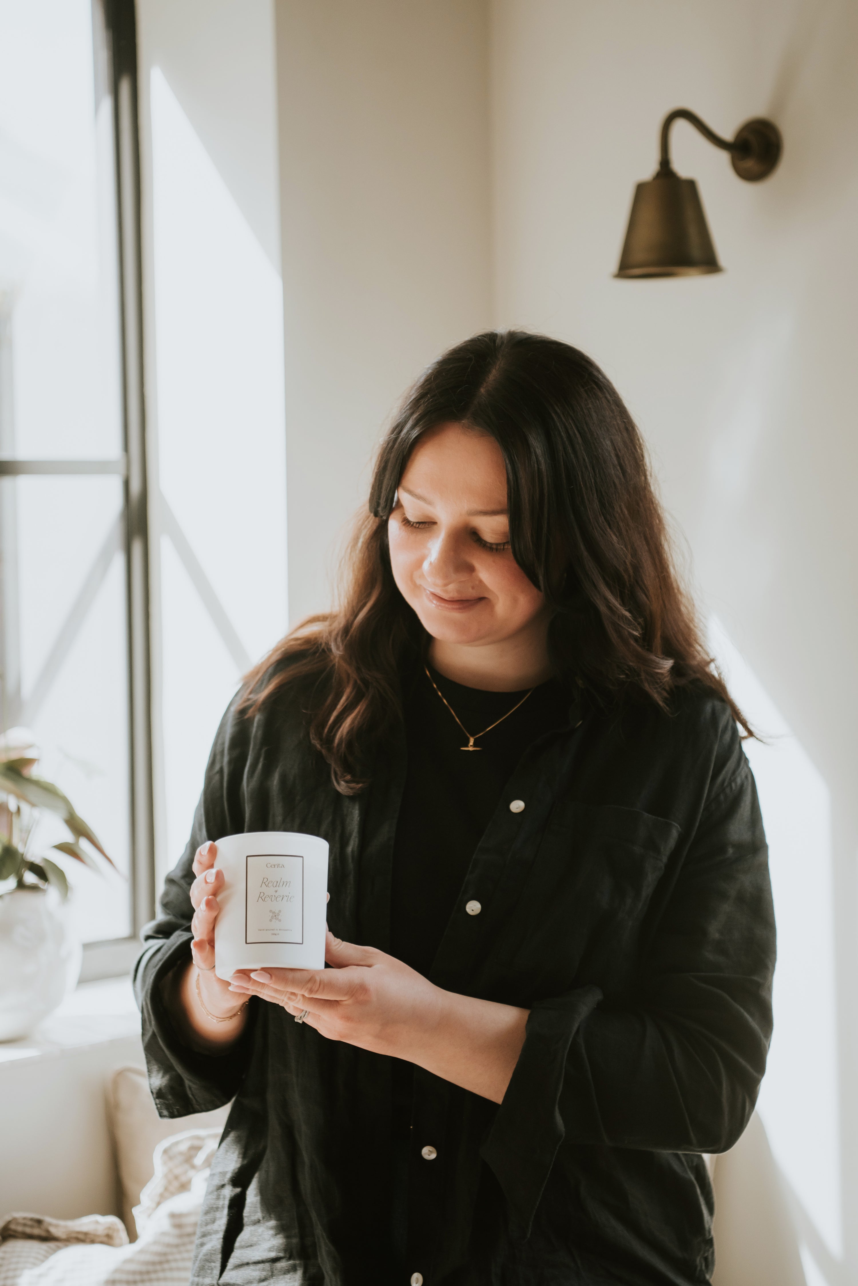 wellbeing and lifestyle brand founder of Cerita holding aromatherapy candle