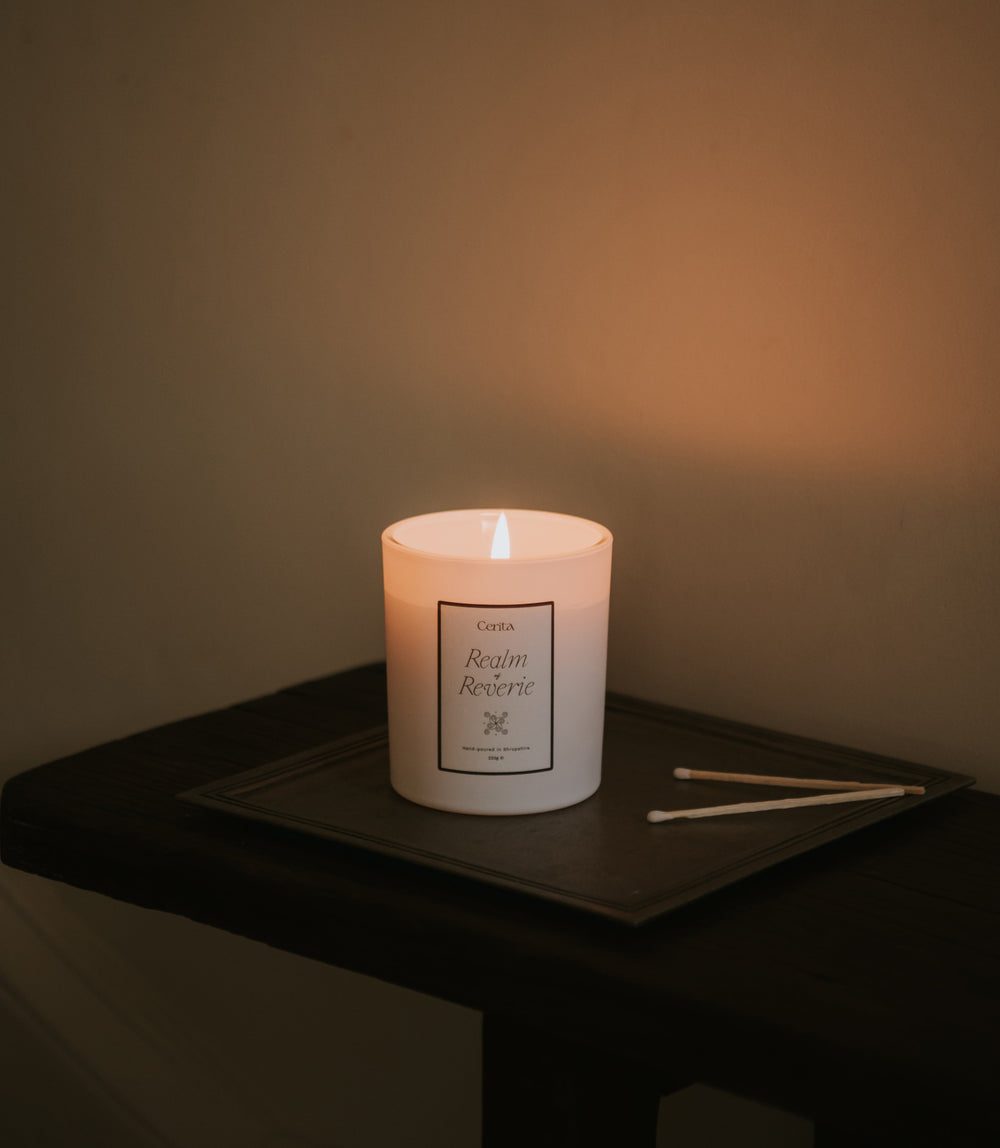 realm of reverie essential oil candle by Cerita on metal tray in neutral interior setting