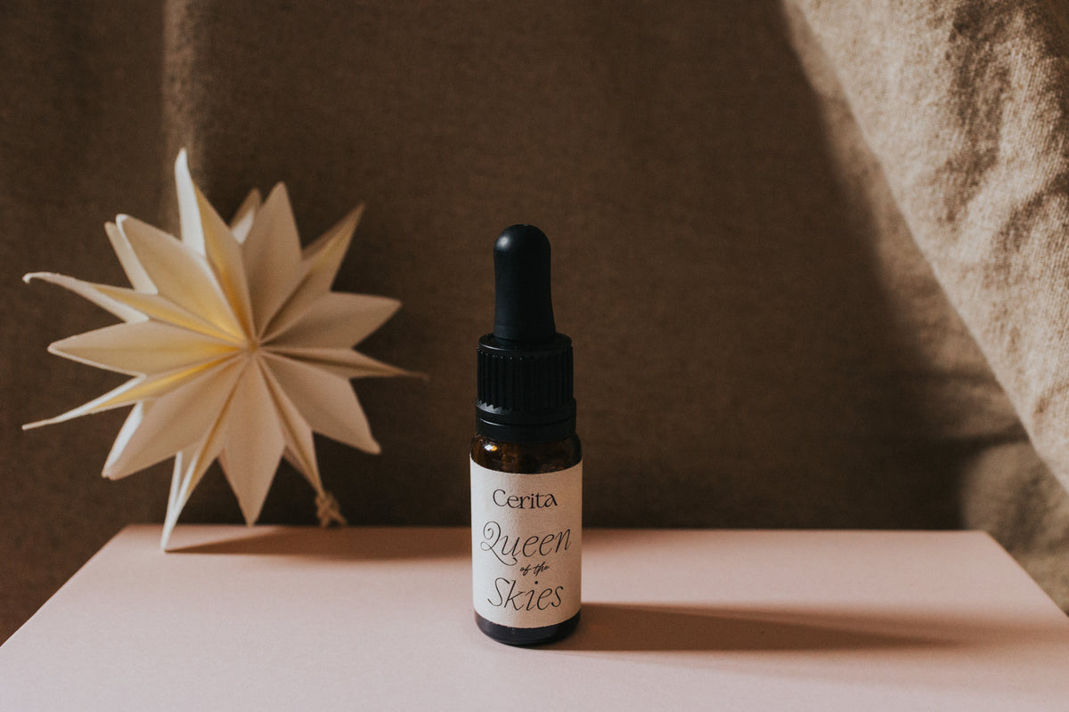 bottle of essential oil blend with origami star decoration on gift box lid
