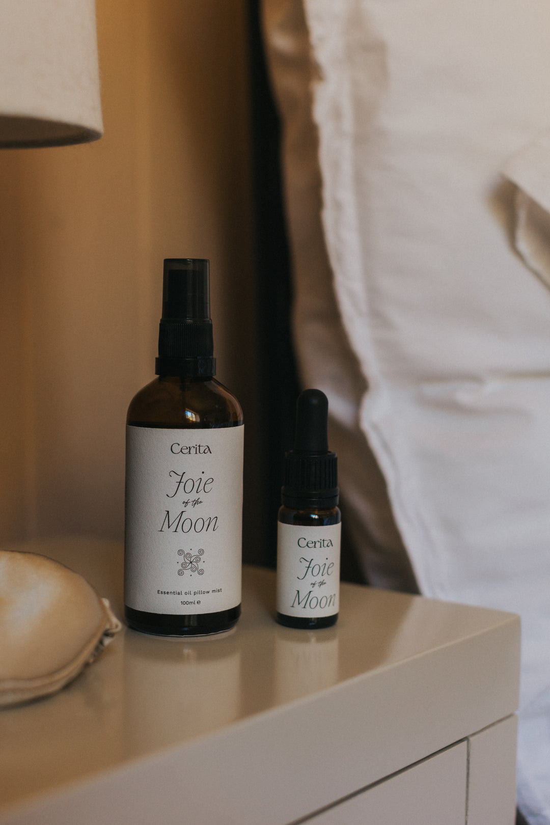 bottles of essential oil blend and pillow mist on bedside table
