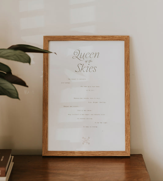 minimal typography a3 paper art print queen of the skies by Cerita in wooden frame on wooden dresser