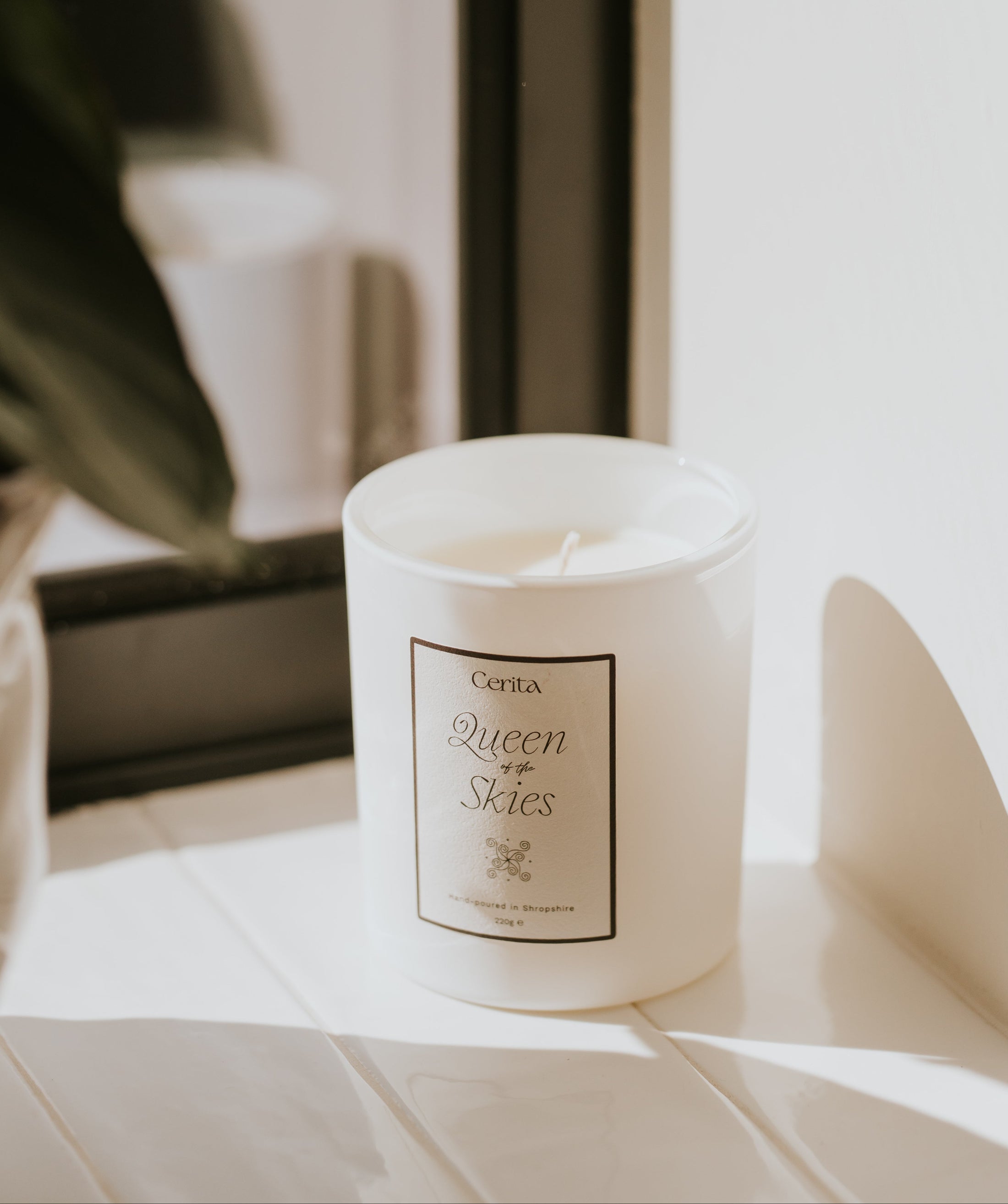 queen of the skies essential oil candle by Cerita on light-filled window sill
