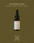 Load image into Gallery viewer, bottle of realm of reverie essential oil blend by Cerita on green background with fragrance notes text
